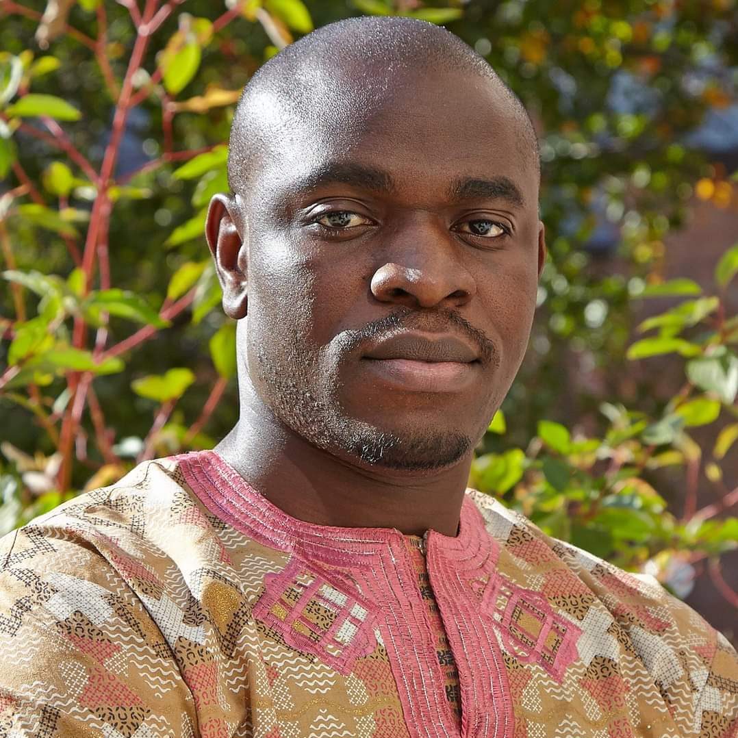 Utibe Effiong, MD, MPH - Headshot in Traditional Gab